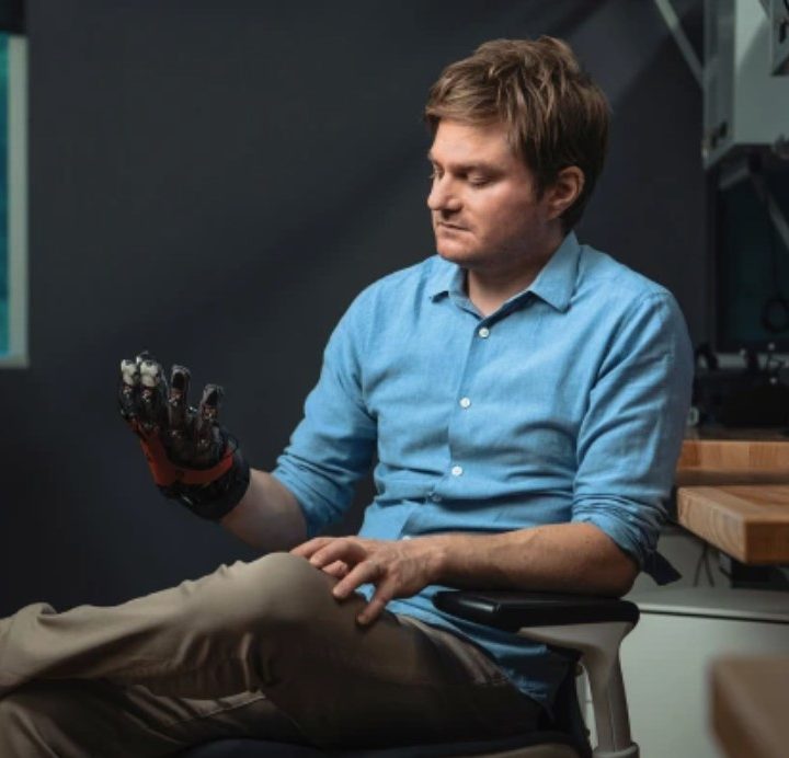 Meta researcher holding prototype haptic glove.
