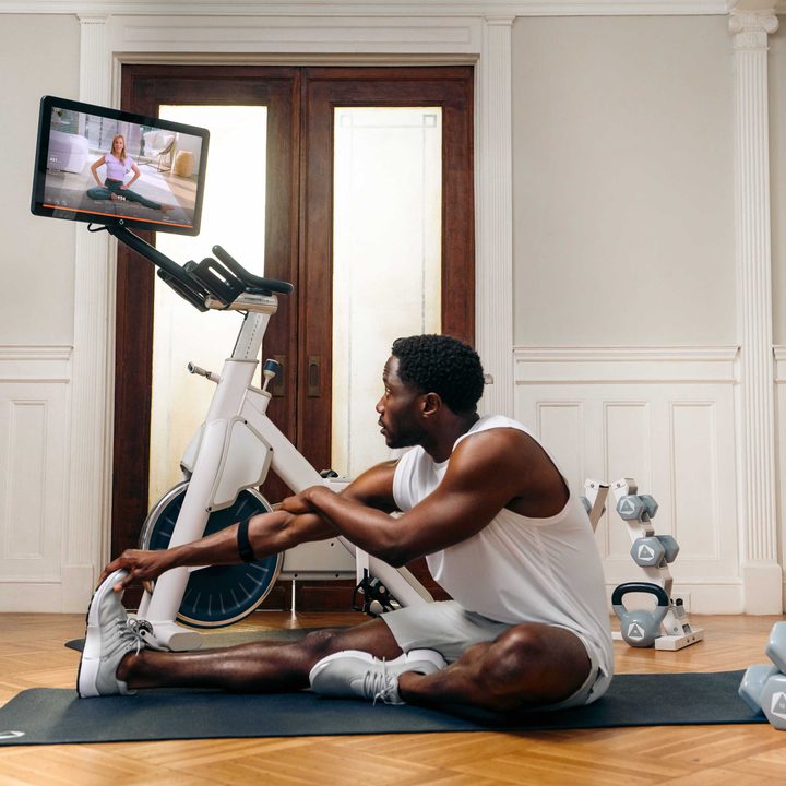 Stretching during an Openfit bike workout.