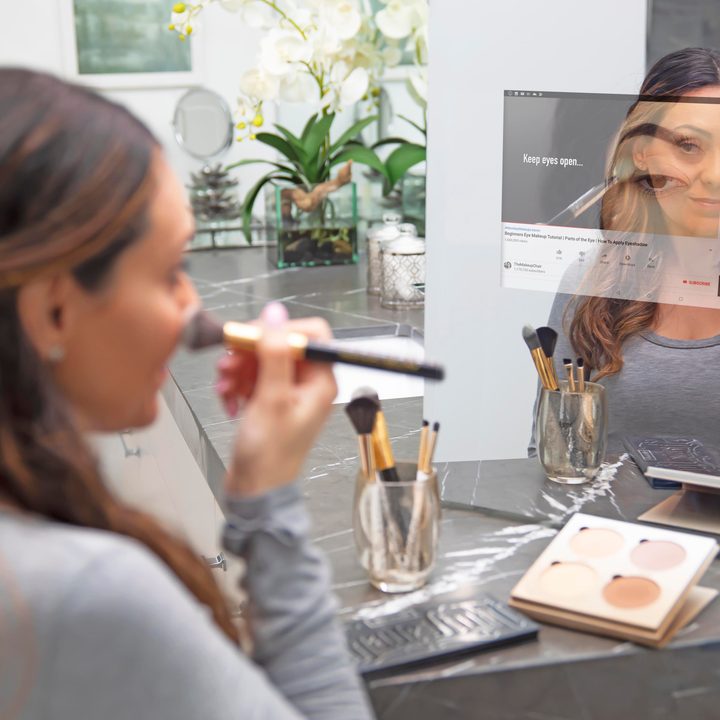 Woman using smart mirror.