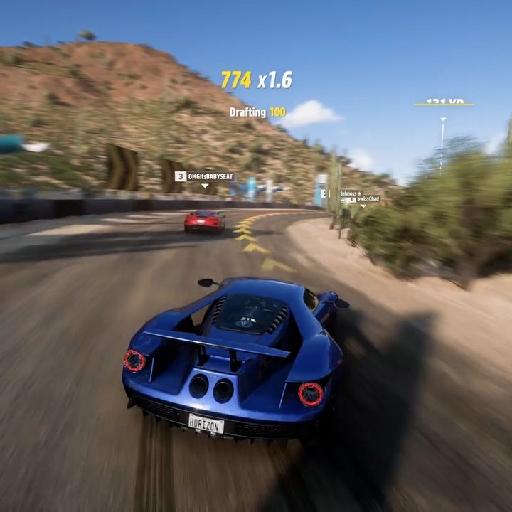 A racecar is using a drift to setup a passing manuever
