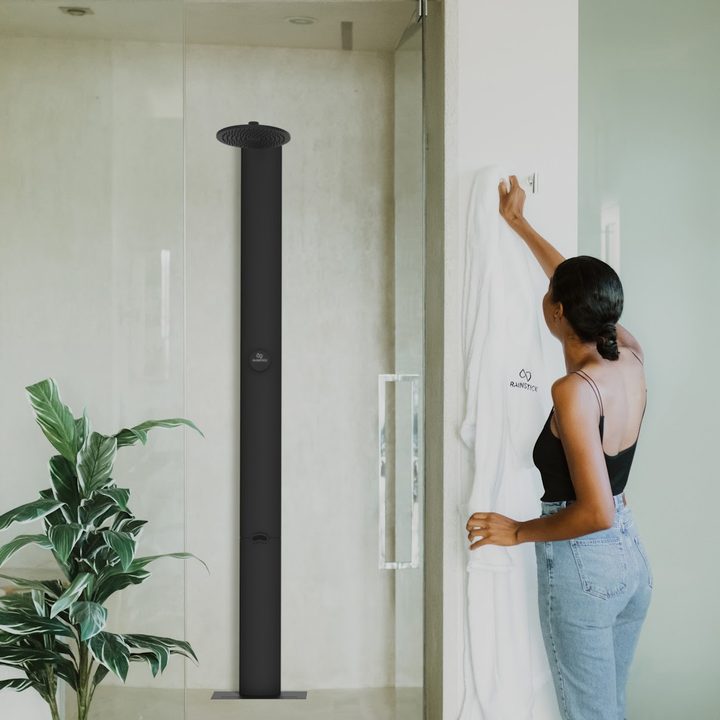 Woman getting ready to use Rainstick shower.