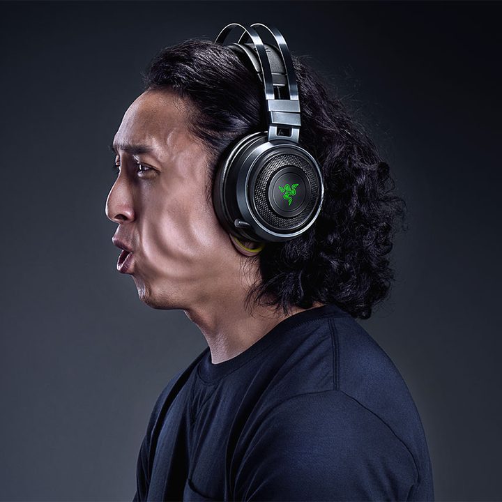 A man's cheeks vibrating with a headset on.