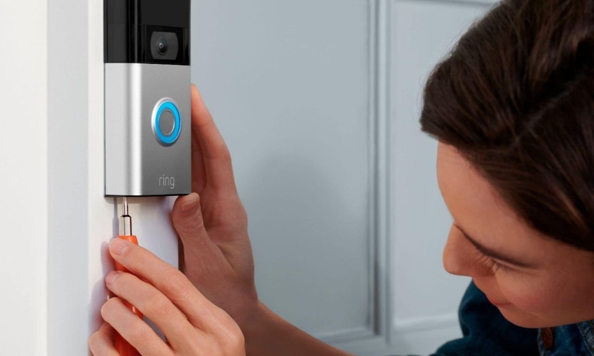 Person installing Ring video doorbell