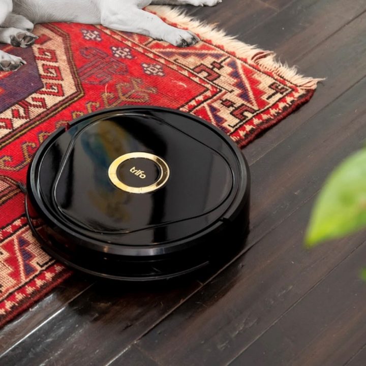 Trifo Lucy Robot Vacuum Cleaner tidying up floor with rug.