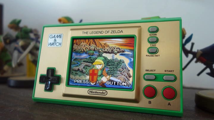 The Zelda Game & Watch sitting near Zelda amiibo.