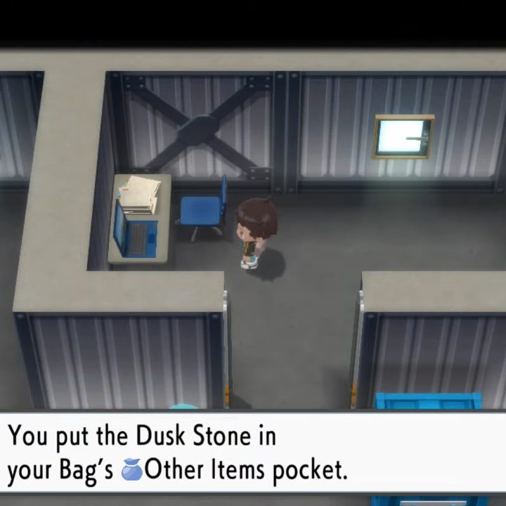 A trainer getting an item off a desk.