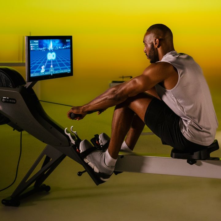 man using an Aviron rowing machine