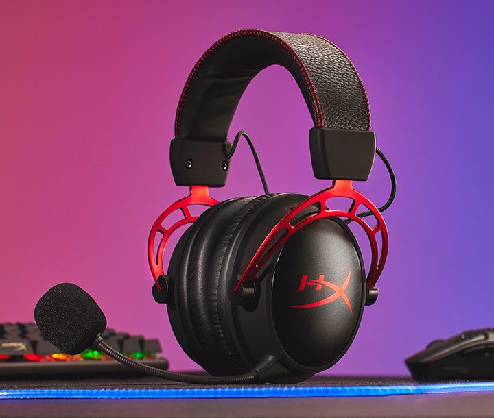 The HyperX Cloud Alpha Wirless headset sitting between a mouse and keyboard.