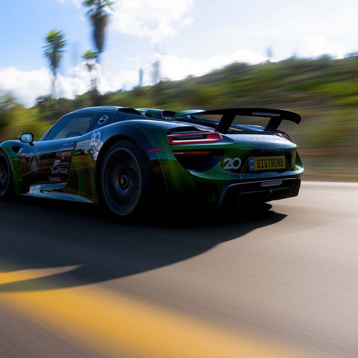 A low-angle shot of a car, speeding past some desert terrain.