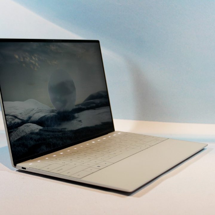 The Dell XPS 13 Plus laptop on a white table.