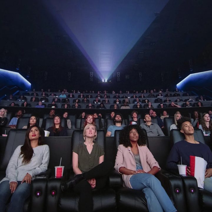 Movie theater audience watching Dolby Cinema content.