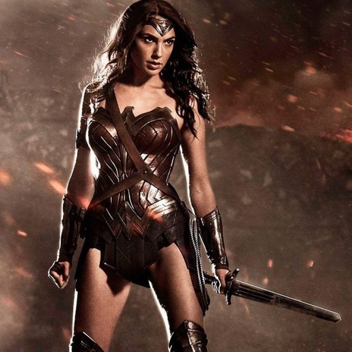 Wonder Woman holds her sword and poses.