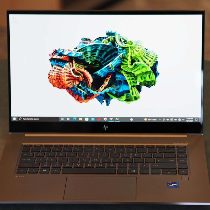 A HP ZBook Studio G8 sits on a table facing forward.