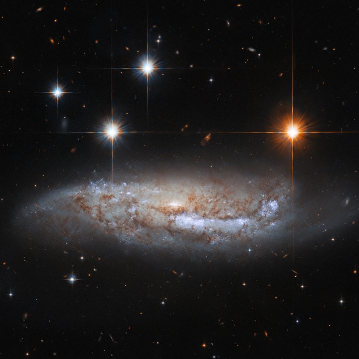 Hubble Space Telescope captures a side-on view of NGC 3568, a barred spiral galaxy roughly 57 million light-years from the Milky Way in the constellation Centaurus.