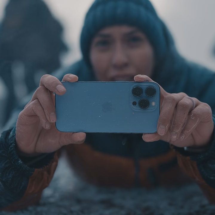 A person takes a picture with an iPhone.