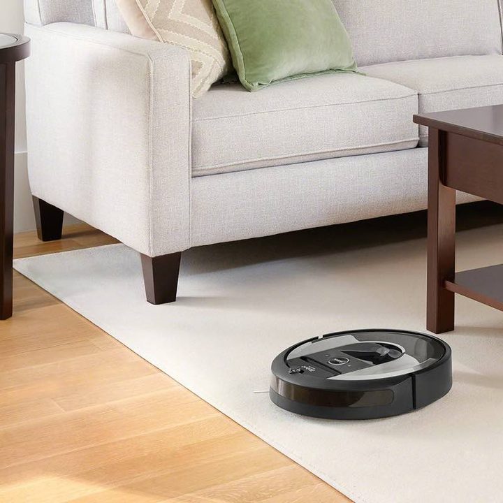 The iRobot Roomba i6 (6150) Wi-Fi Connected Robot Vacuum in a living room.