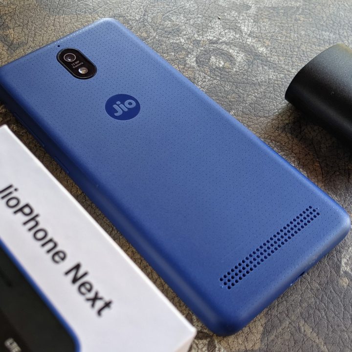 The JioPhone Next next to its retail box and charger.