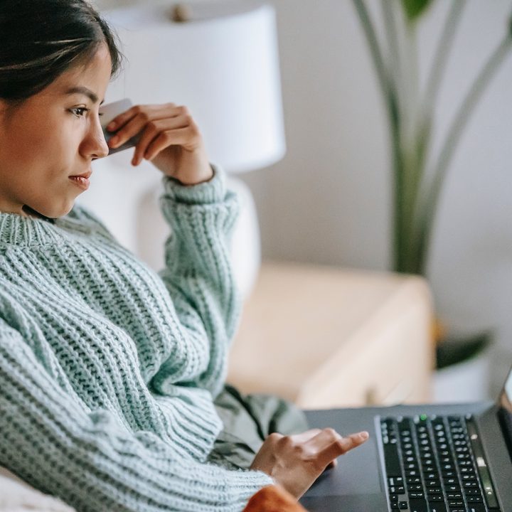 Woman shopping online and protected by McAfee Total Protection.
