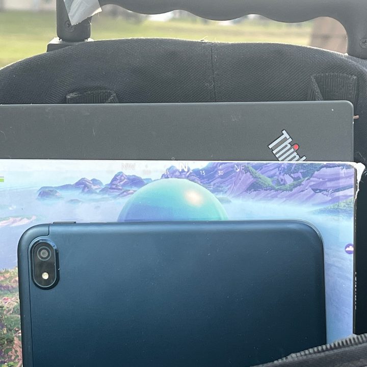 The Nokia T20 tablet tucked into a backpack with several other items.
