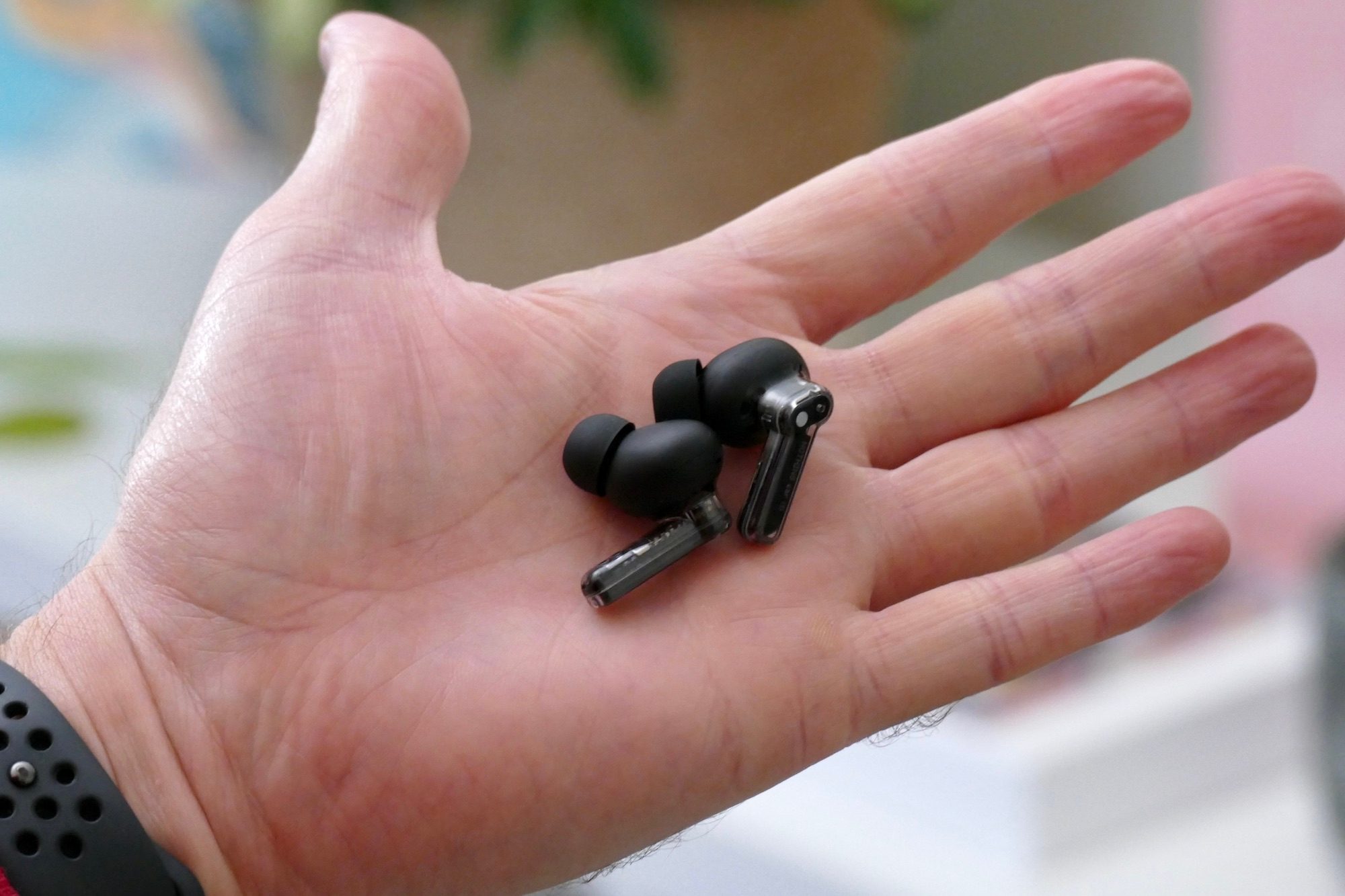 Nothing Ear 1 Black Edition earbuds in hand.