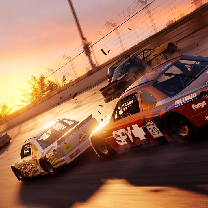 Multiple cars race down a sun-drenched track in Grid Legends.
