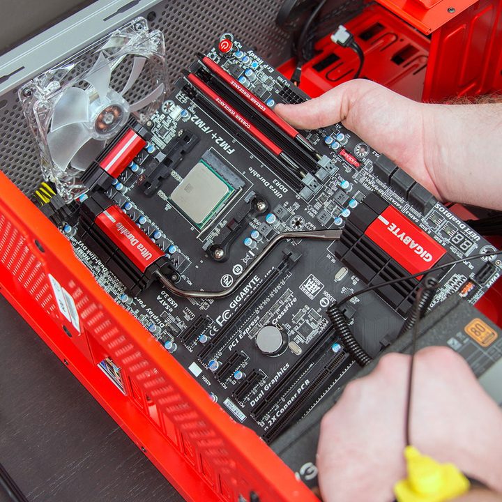 Installing a motherboard in a desktop PC case.