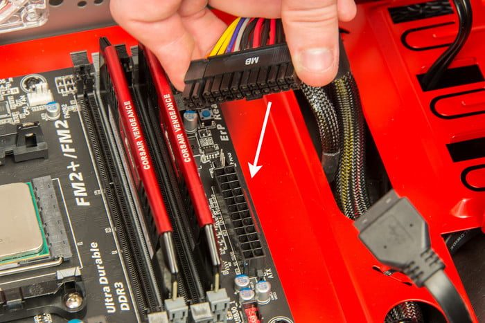 Attaching the 24-pin power connector to a motherboard.