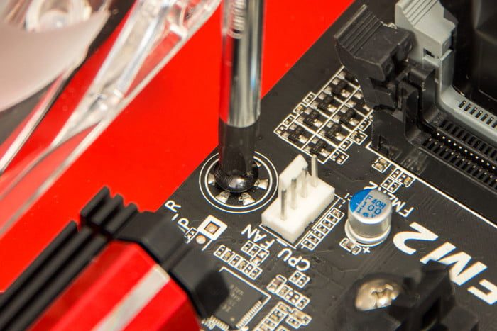 Screwing a motherboard in.