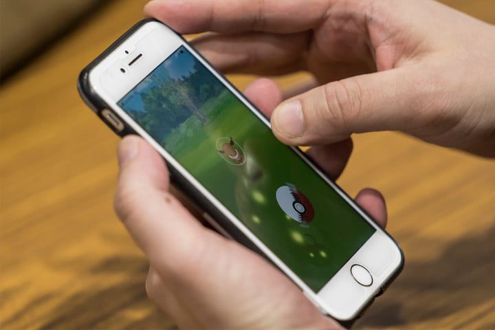 Person playing Pokémon GO on smartphone.