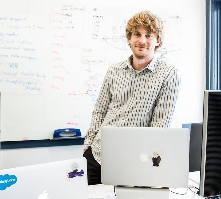 Richard Socher standing in front of a whiteboard
