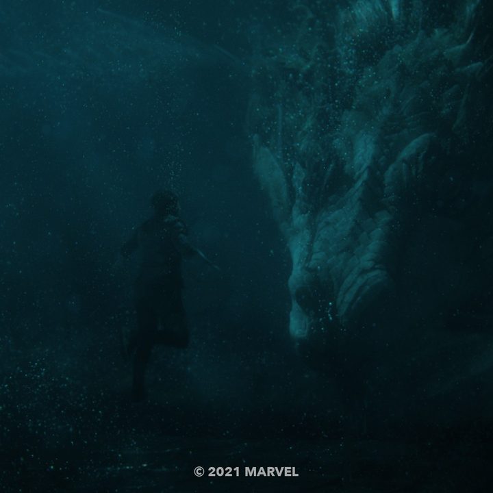 A scene of Simu Liu and a dragon underwater from Shang-Chi and the Legend of the Ten Rings