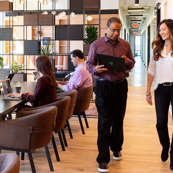 Working in Industrious Office - great days lifestyle image with man and woman.