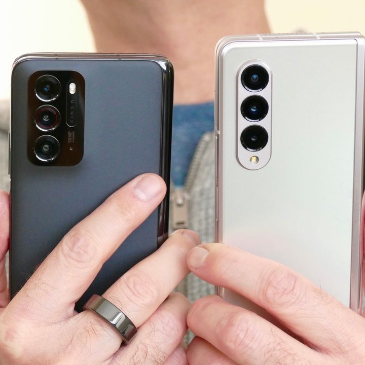 A man holds the Oppo Find N (left) and Galaxy Z Fold 3.