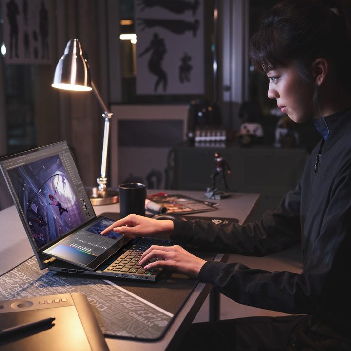 A woman using the second screen of the ROG Zephyrus Duo 16.