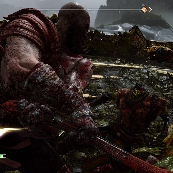 Kratos decapitates an enemy in God of War
