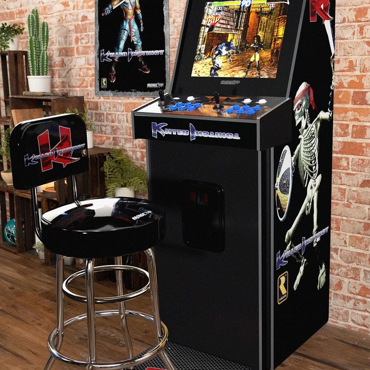 Arcade1Up's Pro Series Killer Instinct arcade cabinet stands against a brick wall.