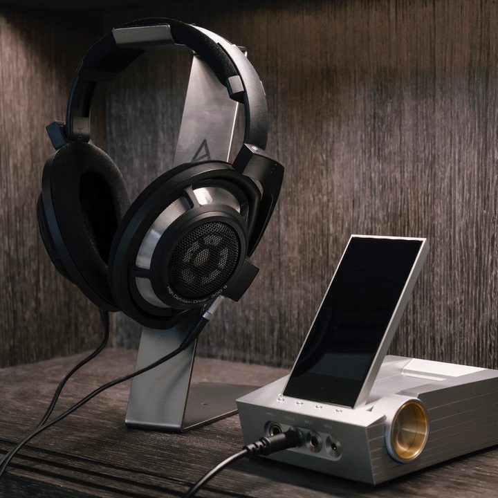 Astell&Kern Arco CA1000 headphone amp and digital audio player seen with headphones.