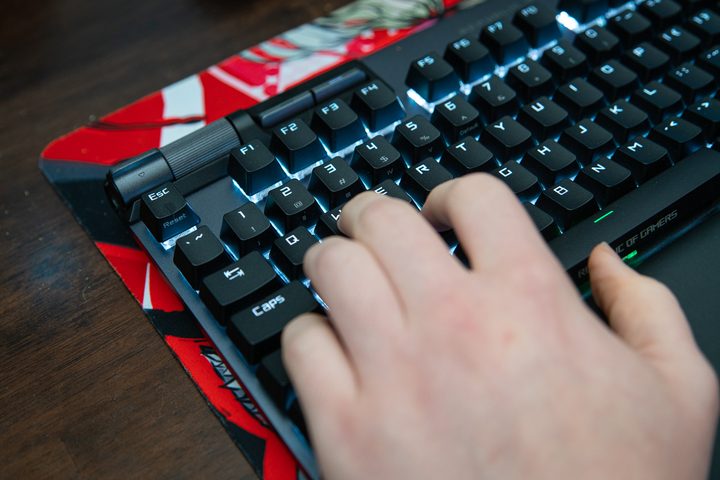 Fingers on WASD on a gaming keyboard.
