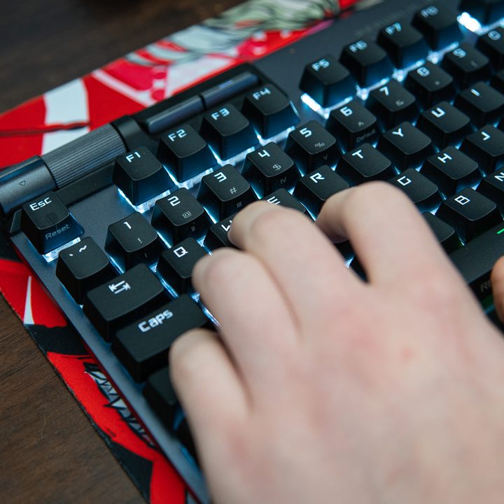 Fingers on WASD on a gaming keyboard.