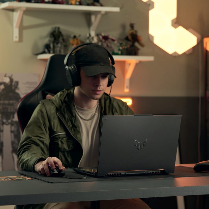 A person using the Asus TUF F15 gaming laptop.