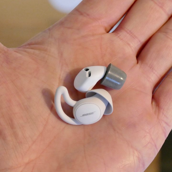 Bose SleepBuds 2 and QuietOn 3 earbuds in a hand.