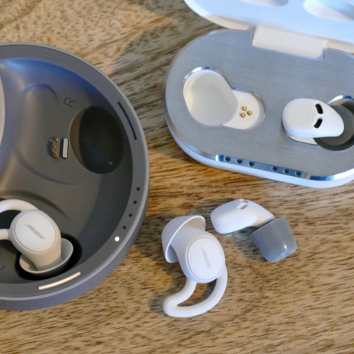 The Bose SleepBuds 2 and QuietOn 3 with cases open and one earbud removed from each.