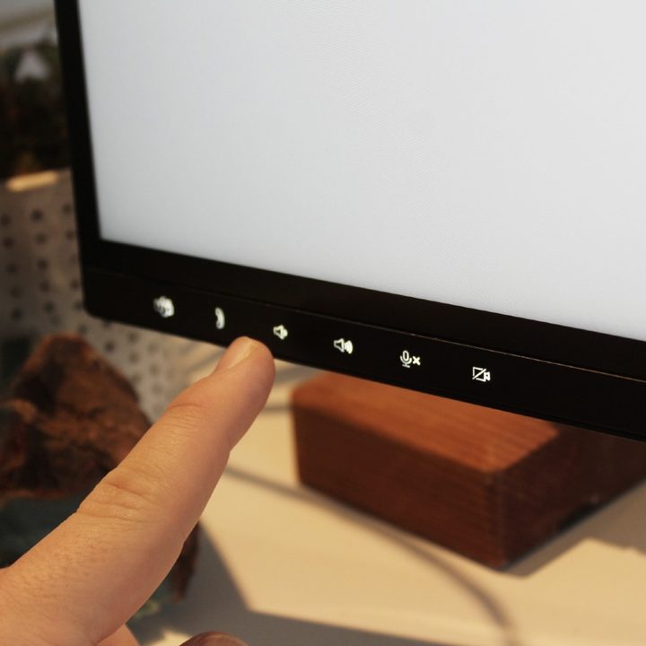 The capacitive touch buttons on the bottom bezel of the monitor.