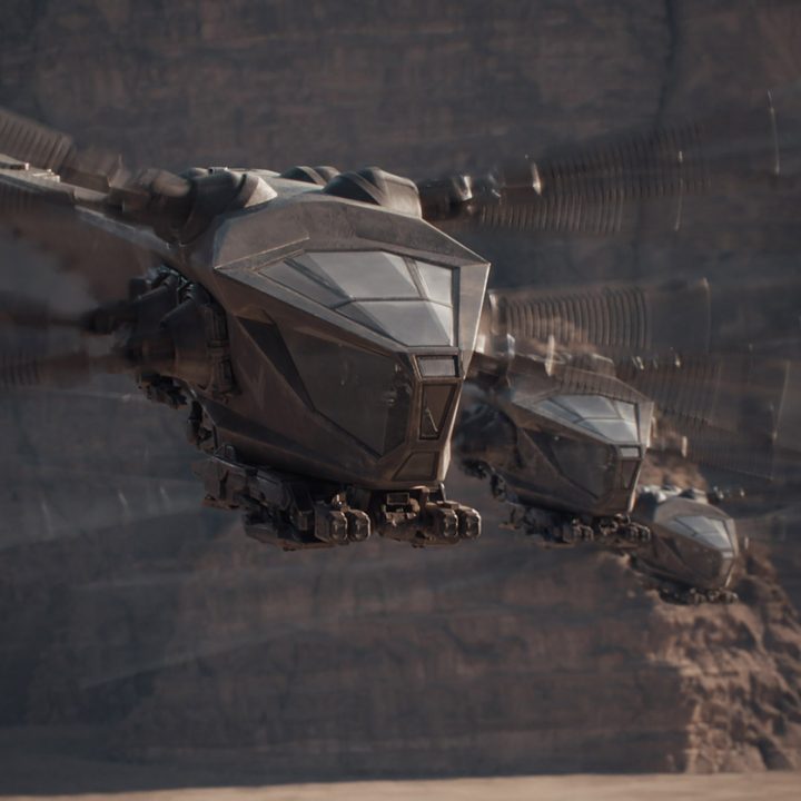 Winged ornithopters flying over sand dunes in Dune.