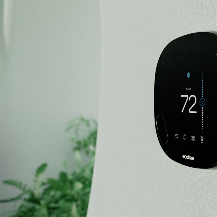 Ecobee thermostat mounted on a wall.