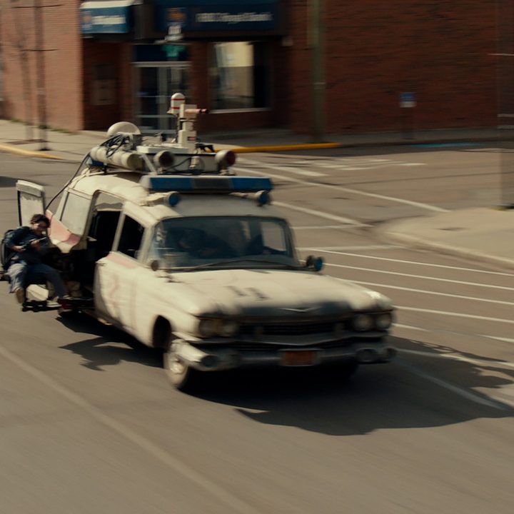 The Ecto-1 drives down the street in an early VFX shot from Ghostbusters: Afterlife.