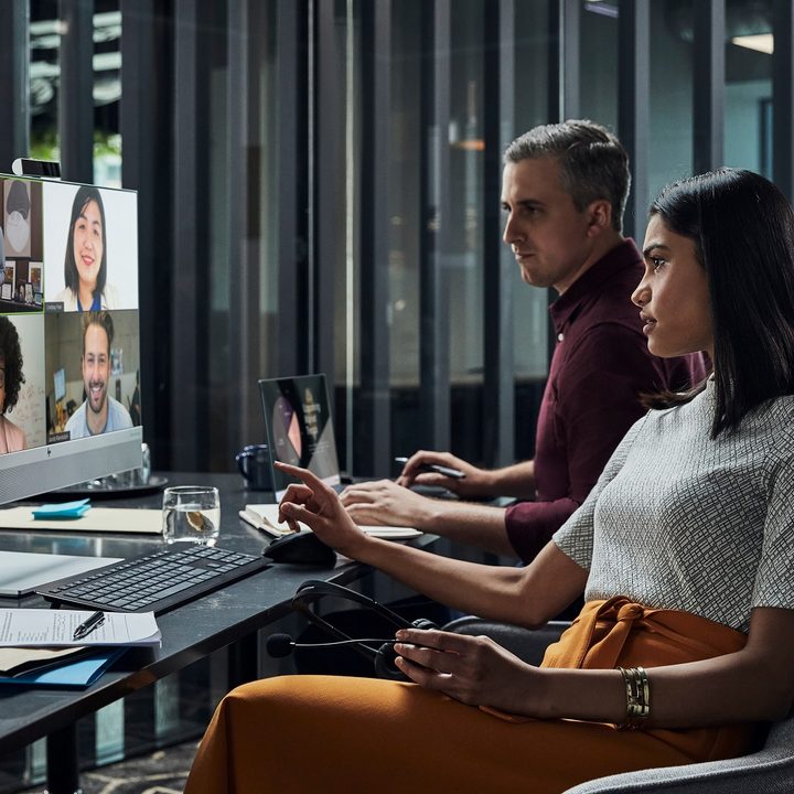 Two people work at an HP all-in-one PC.