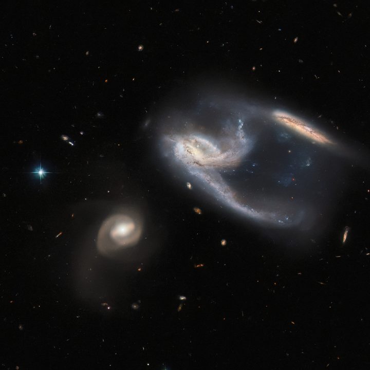 A group of three galaxies, collectively known as NGC 7764A, imaged by the NASA/ESA Hubble Space Telescope.