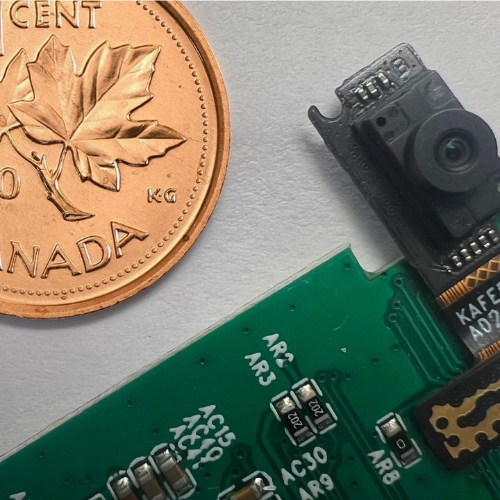 Immervision's new small webcam module, next to a Canadian coin.