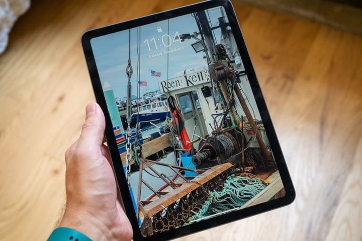 Apple iPad Air 4 held in hand.